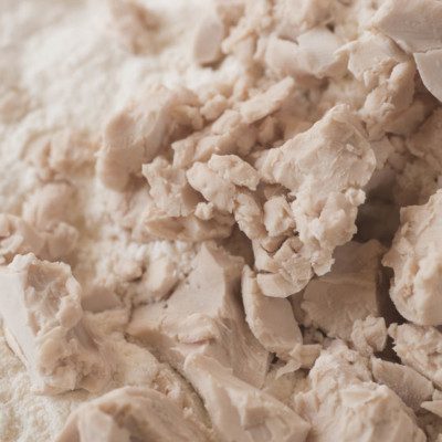 Yeast performance testing encompasses various procedures for determining either the time required for dough to reach a certain volume or the volume of dough at a given proof time.