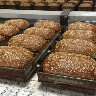 Pan lubrication is a critical step in high-speed bakeries processing thousands of loaves per hour.