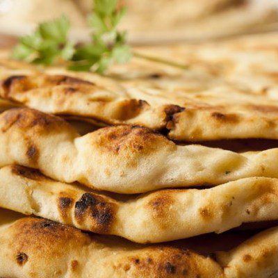Flatbread is characterized by its low specific volume and high crust-to-crumb ratio.