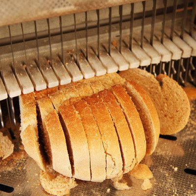 Bread slicing involves cutting or slicing loaves into individual pieces for convenience and portion-controlled servings for consumers