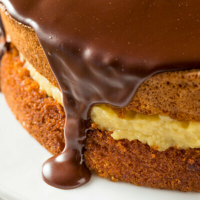 Boston cream pie is not a pie at all but a sponge cake (or other yellow batter cake) filled with a pastry cream and topped with a freshly cooled chocolate ganache for enrobing.